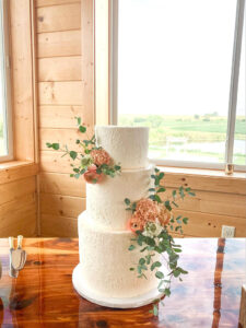 Three tiered cake with rose texture and fresh floral
